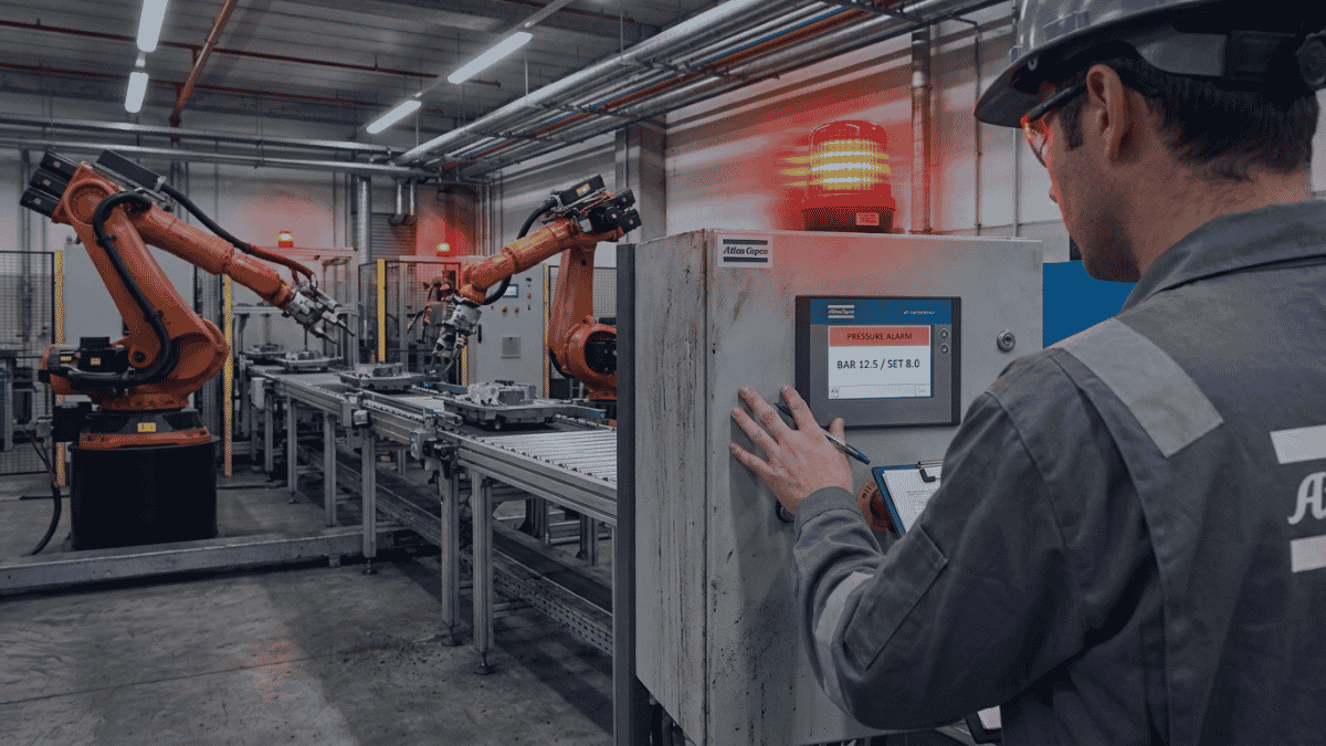 Why Air Compressors Fail Common Causes of Industrial Downtime 4 Technician performing preventative maintenance on an industrial air compressor system to prevent downtime and equipment failure.